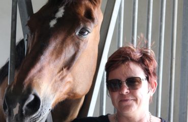 Tami enjoys a moment with Feliki – a horse who has taught Tami how to live Photo by Johnny Robb